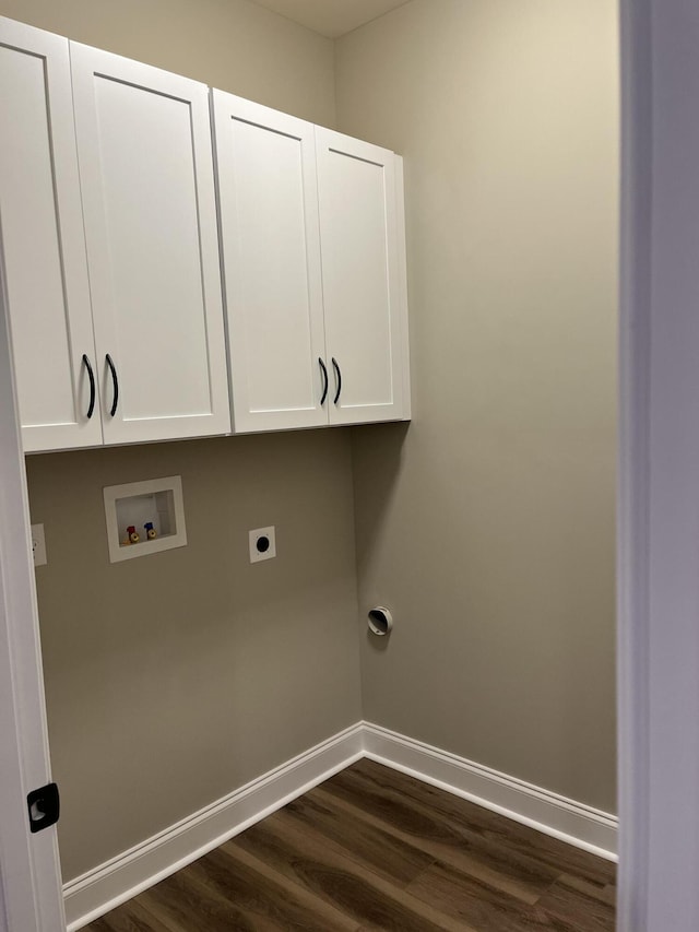 clothes washing area featuring baseboards, cabinet space, washer hookup, and dark wood finished floors