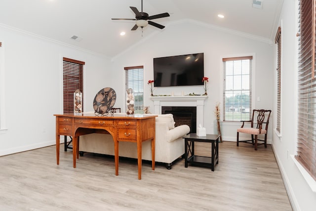 living room with visible vents, a fireplace, ornamental molding, a ceiling fan, and light wood-style floors