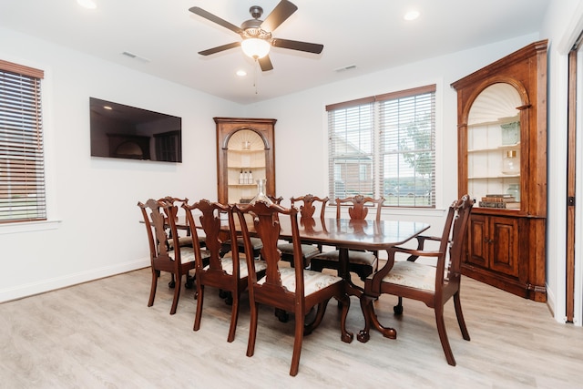 dining room with visible vents, light wood-style flooring, and a ceiling fan