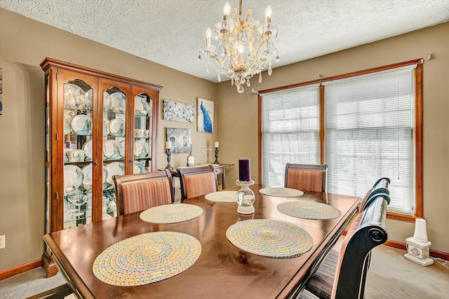 carpeted dining room featuring a textured ceiling, a chandelier, and a wealth of natural light