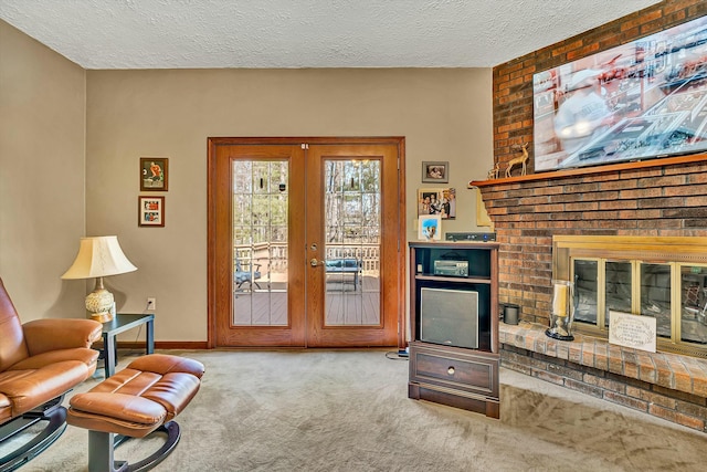 interior space featuring french doors, carpet flooring, baseboards, a textured ceiling, and a brick fireplace