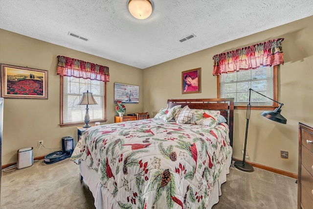 bedroom featuring baseboards, carpet floors, and visible vents