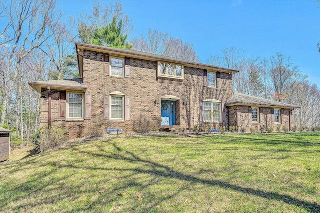 view of front facade featuring a front yard and brick siding