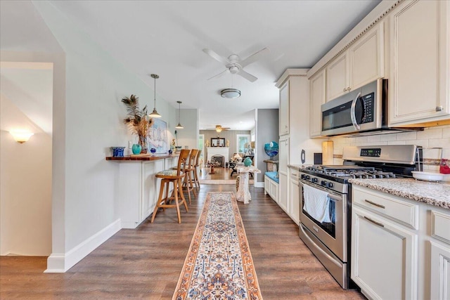 721 Mount Vernon Ave, Salem, VA 24153 - kitchen with a ceiling fan, dark wood-style flooring, stainless steel appliances, and tasteful backsplash