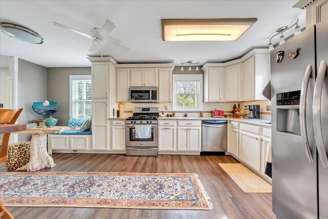 721 Mount Vernon Ave, Salem, VA 24153 - kitchen featuring backsplash, wood finished floors, appliances with stainless steel finishes, cream cabinetry, and ceiling fan