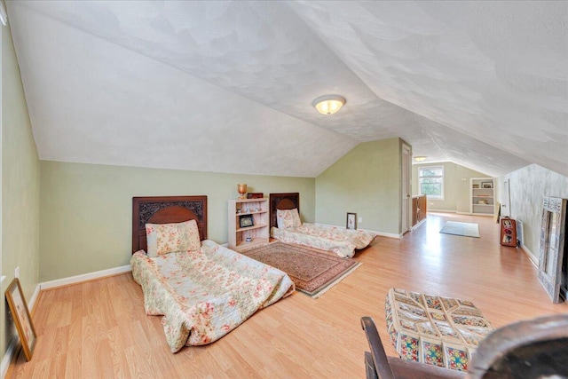 721 Mount Vernon Ave, Salem, VA 24153 - bedroom featuring baseboards, a textured ceiling, wood finished floors, and vaulted ceiling