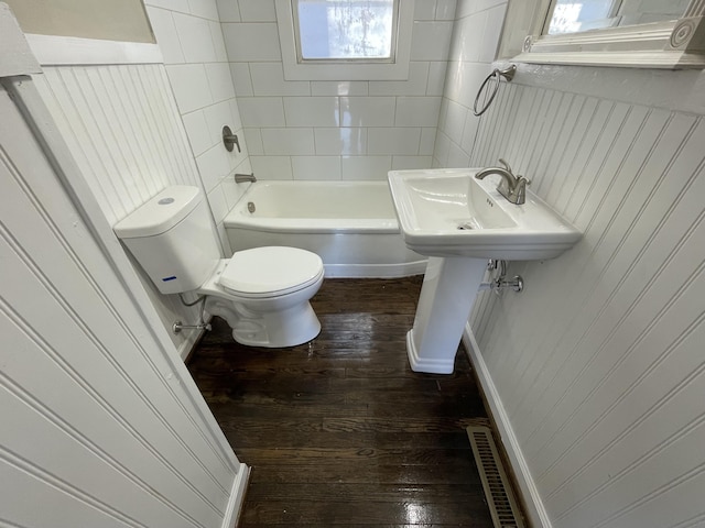 full bathroom featuring visible vents, toilet, bathing tub / shower combination, and wood finished floors