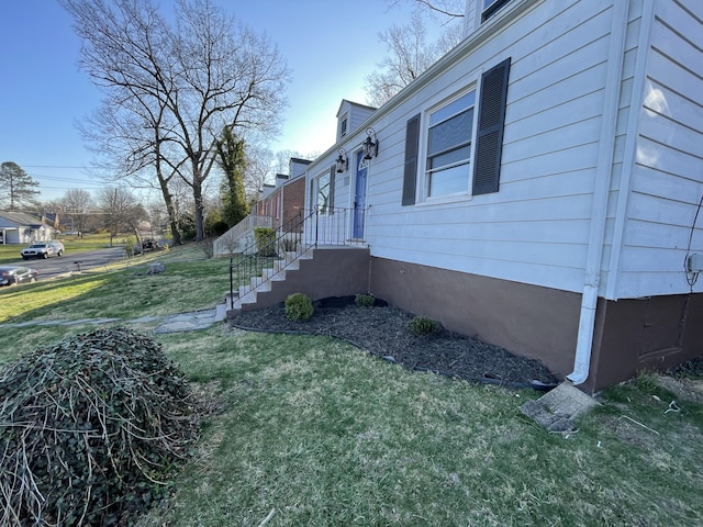 view of property exterior featuring a lawn