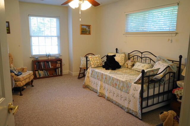 bedroom featuring baseboards, a ceiling fan, and carpet