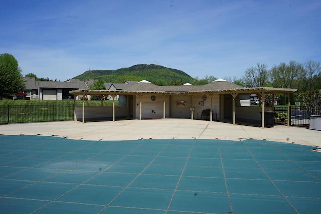 exterior space featuring fence, a patio, a mountain view, and a fenced in pool