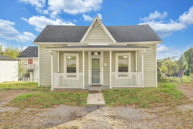 bungalow-style house with covered porch and a shingled roof