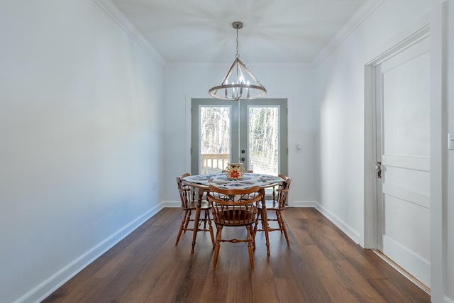 dining area featuring dark wood-style floors, a notable chandelier, baseboards, and french doors