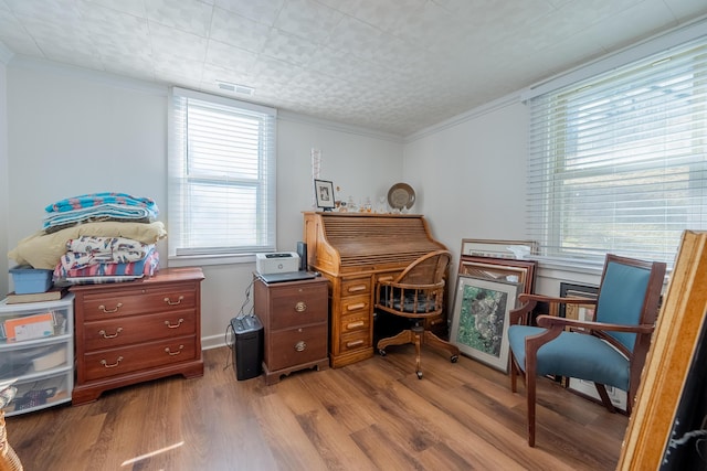 office space featuring visible vents, crown molding, and wood finished floors