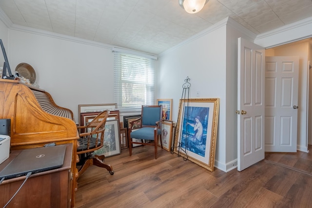 office area with baseboards, crown molding, and wood finished floors