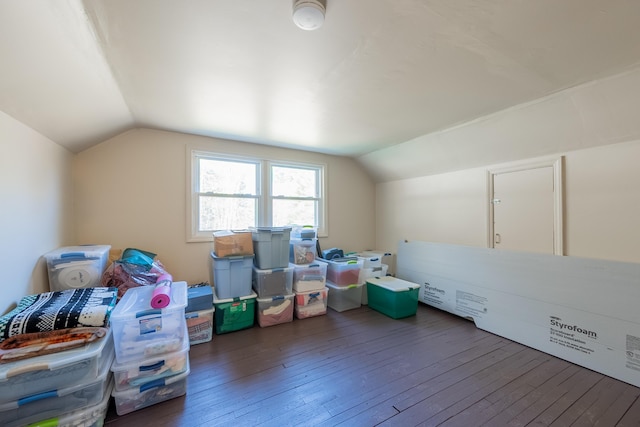 additional living space with hardwood / wood-style floors and lofted ceiling