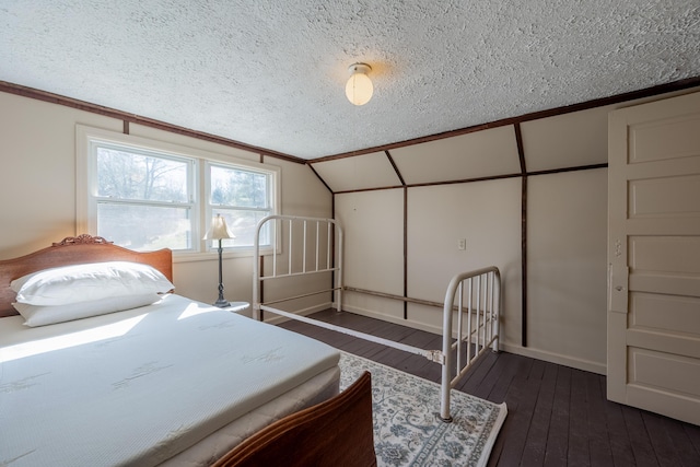 3512 Conner Grove Rd SW, Willis, VA 24380 - bedroom featuring a textured ceiling, dark wood finished floors, lofted ceiling, and baseboards