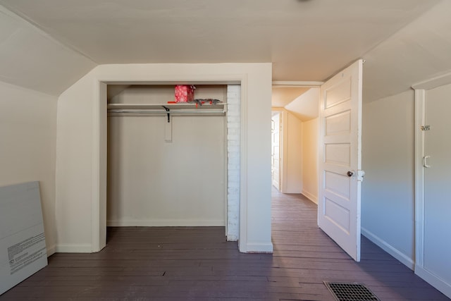 unfurnished bedroom with dark wood-style flooring, baseboards, a closet, and visible vents