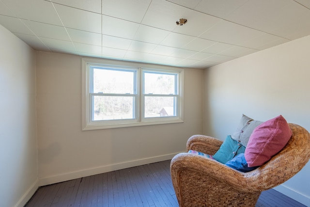 living area with hardwood / wood-style flooring and baseboards