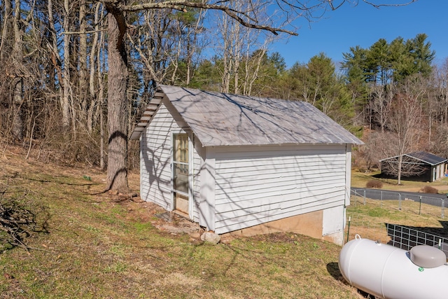 view of shed featuring fence