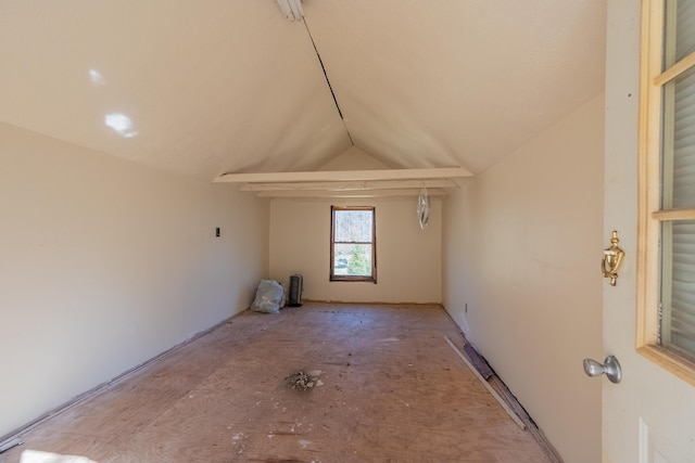 spare room with vaulted ceiling