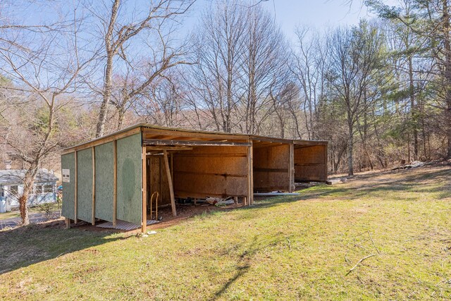 view of pole building with a detached carport and a yard