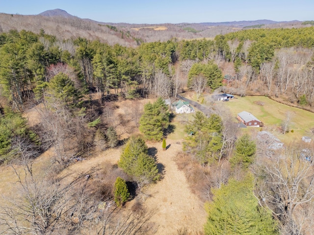 drone / aerial view with a mountain view and a view of trees