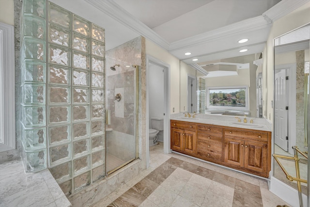 bathroom featuring toilet, a stall shower, a sink, and ornamental molding
