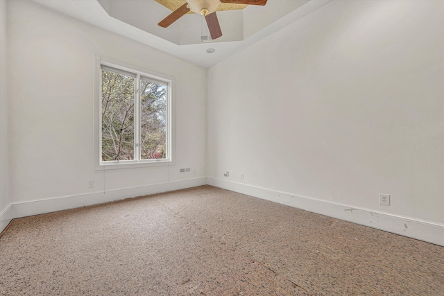 spare room featuring baseboards and a ceiling fan