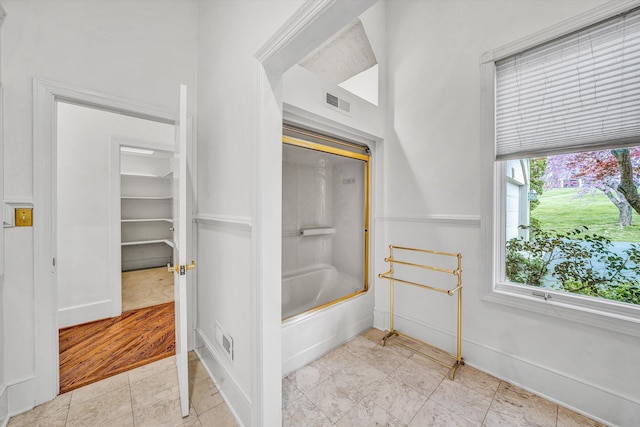 full bath with visible vents, baseboards, and shower / washtub combination