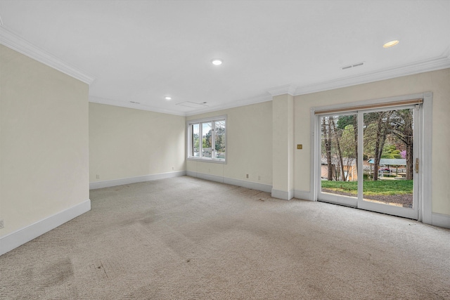 spare room featuring light carpet, visible vents, baseboards, and ornamental molding