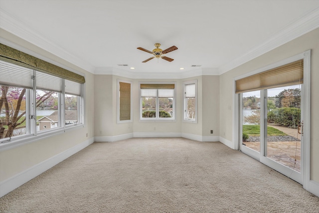 empty room featuring a ceiling fan, light carpet, baseboards, and ornamental molding