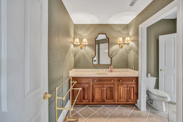 bathroom featuring visible vents, toilet, vanity, and tile patterned flooring