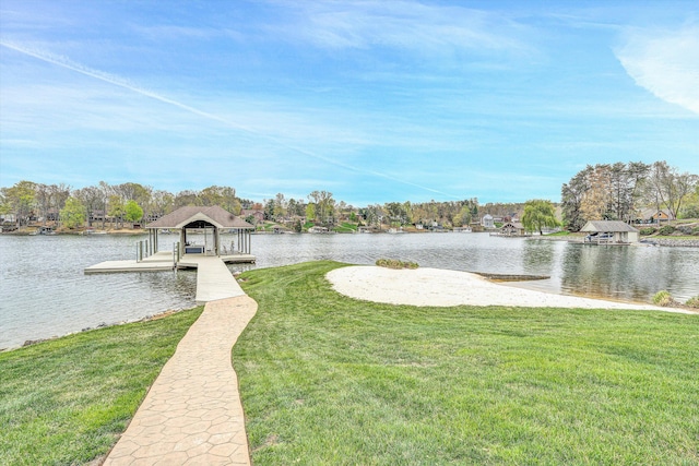 view of dock with a yard and a water view