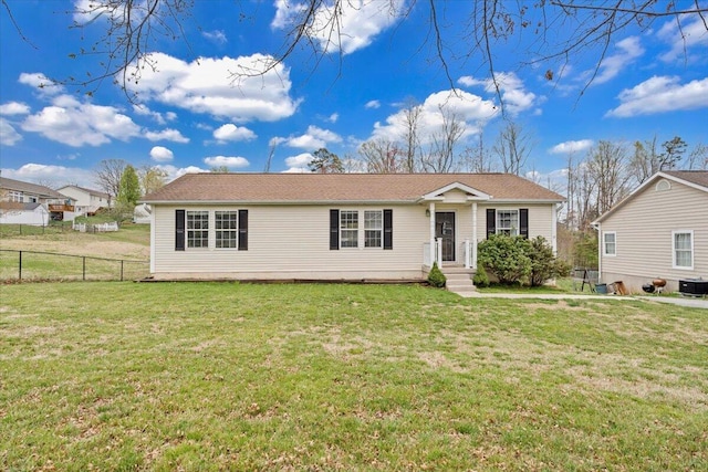 single story home with fence and a front lawn