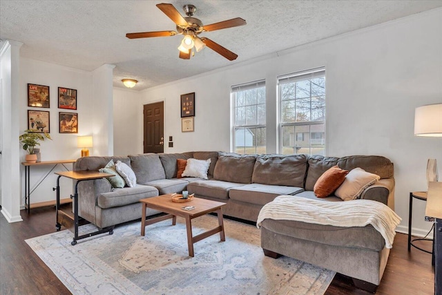 living room with crown molding, baseboards, a textured ceiling, ceiling fan, and wood finished floors