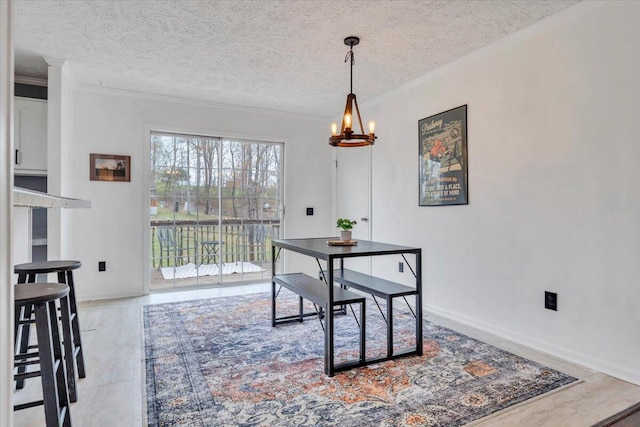 dining area featuring baseboards, a textured ceiling, and a chandelier