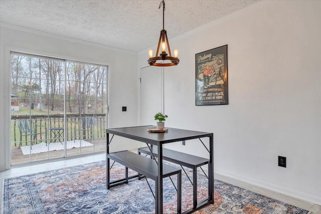 dining space with a textured ceiling, crown molding, tile patterned floors, and a chandelier