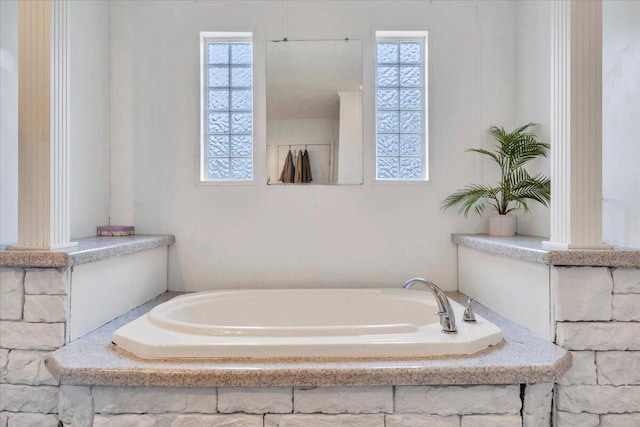 bathroom with plenty of natural light and a garden tub