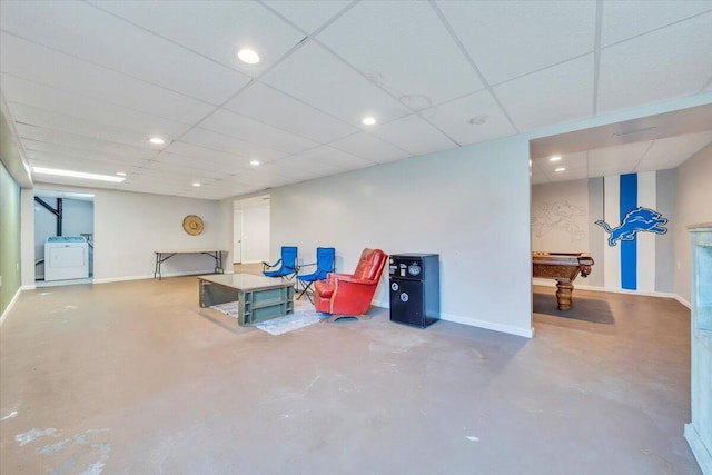 interior space featuring baseboards, billiards, washer / clothes dryer, and a drop ceiling