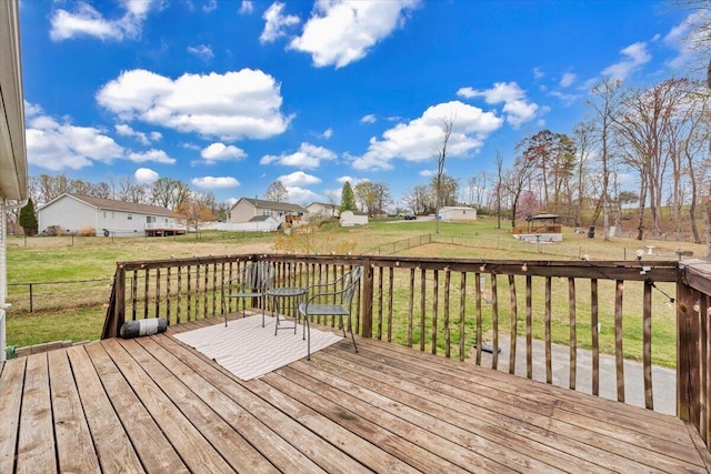 wooden deck with fence, a yard, and a residential view