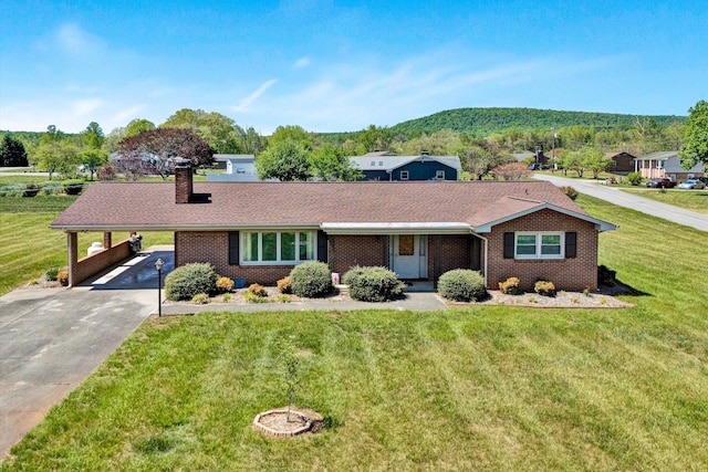 ranch-style home featuring driveway, a chimney, a front yard, a carport, and brick siding