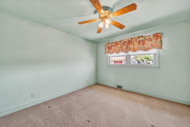 carpeted empty room with a ceiling fan, baseboards, and visible vents
