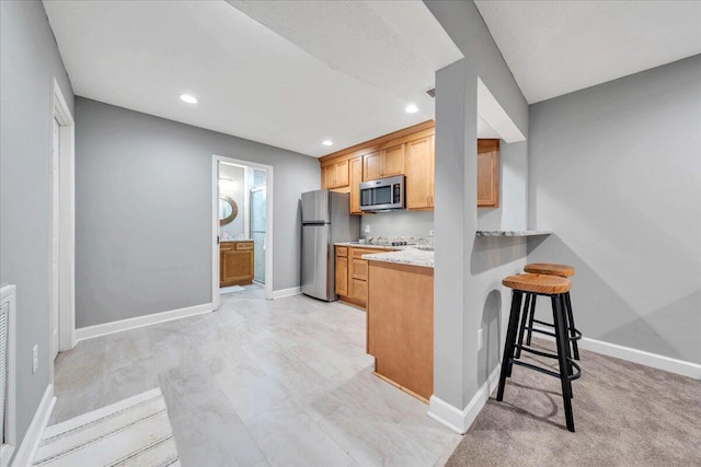 20 Ohara Dr, Daleville, VA 24083 - kitchen featuring light stone countertops, a kitchen bar, recessed lighting, appliances with stainless steel finishes, and baseboards