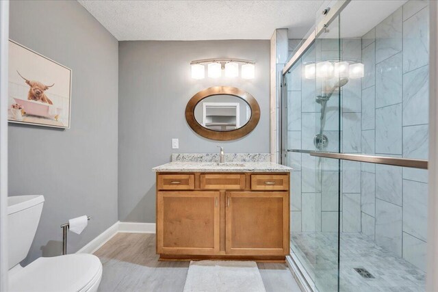 20 Ohara Dr, Daleville, VA 24083 - full bathroom with toilet, a textured ceiling, a shower stall, vanity, and wood finished floors