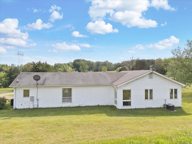 view of side of home featuring a lawn and cooling unit