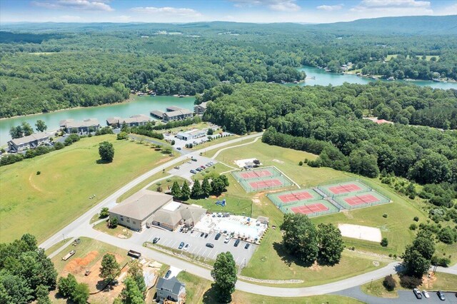 bird's eye view with a wooded view and a water view