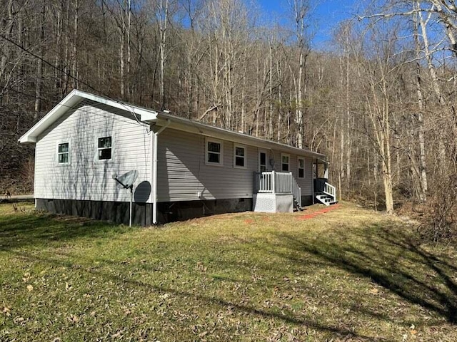 1615 Dolly Ann Dr, Covington, VA 24426 - back of property featuring a yard, crawl space, and a forest view