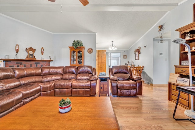 10131 Sontag Rd, Martinsville, VA 24112 - living area with a textured ceiling, light wood finished floors, ornamental molding, ceiling fan with notable chandelier, and vaulted ceiling