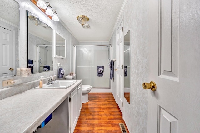10131 Sontag Rd, Martinsville, VA 24112 - bathroom featuring crown molding, toilet, a shower stall, wood finished floors, and visible vents