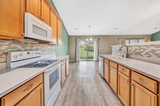 6815 Cee St, Roanoke, VA 24019 - kitchen with light wood finished floors, a sink, decorative light fixtures, backsplash, and white appliances